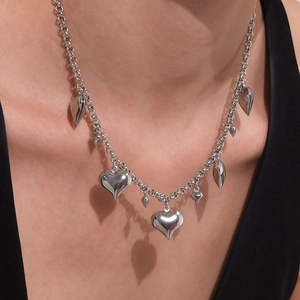 Silver stainless steel heart pendant necklace with chunky chain design on model