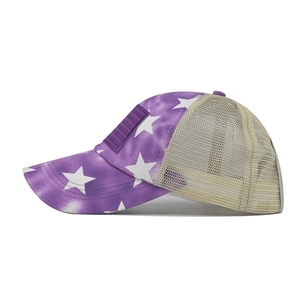 Detail of purple cotton baseball cap featuring white star patterns and mesh panels