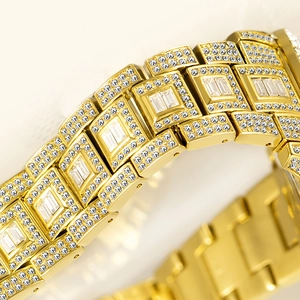 Macro detail of gold-tone watch strap featuring rectangle and pave-set crystals