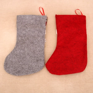 Detailed view of red and grey felt Christmas stockings with hanging loops for holiday decor