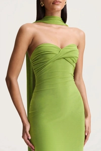Detail of green halter neck dress with heart-shaped neckline and pleated chest design