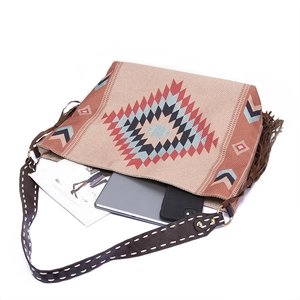 Detail of bohemian tote bag with geometric patterns, fringe trim and large storage capacity