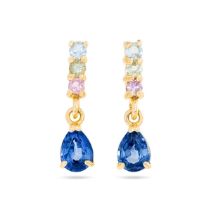 Detailed view of dangling earrings featuring colorful round stones and a large blue teardrop gem