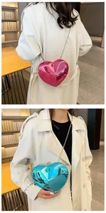 Detail of metallic heart-shaped crossbody bags in glossy pink and blue with chain straps