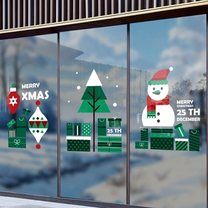 Christmas window decals with snowman and Xmas tree designs on glass storefront