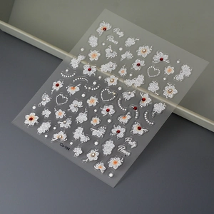 Detail of white flower nail stickers Co-164 with red rhinestones and pearl accents