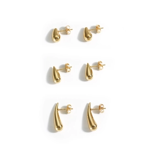 Three pairs of polished golden teardrop earrings in various sizes on white background