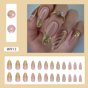 Detail view of W913 press-on nails featuring nude pink finish with gold glitter accents