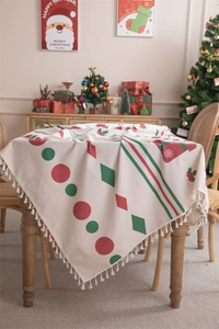 Detail of Christmas tablecloth with red-green geometric patterns and white tassels