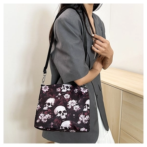 Lifestyle view of the shoulder bag with skull and floral print on a gray blazer