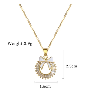 Elegant gold titanium necklace with a micro-pave zircon wreath and white bow pendant