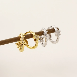 Detail view of s925 silver star and moon hoop earrings with pavé crystals