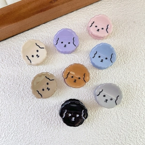 Set of 8 cute puppy resin hair clips in various colors arranged on white texture