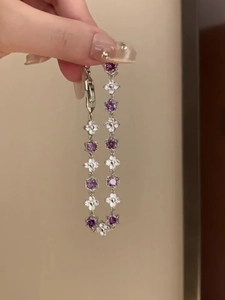 Detail view of silver floral bracelet with purple and white zircon flower charms