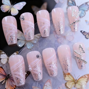 Pink gradient press-on nails with silver glitter, 3D butterfly, and pearl accents