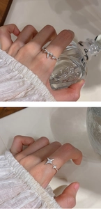 Detail of silver bowknot and star rings with shimmering cubic zirconia settings