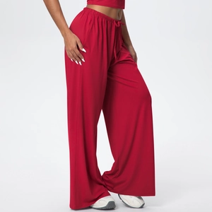 Detail of red wide-leg lounge pants with drawstring waist and deep side pockets