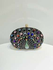 Macro detail of the peacock pattern featuring sparkling rhinestones on the evening clutch