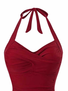 Detail of burgundy halter one-piece swimsuit with wrap front cross design and pleats