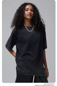 Detail of vintage washed black oversized t-shirt with retro faded texture and street style