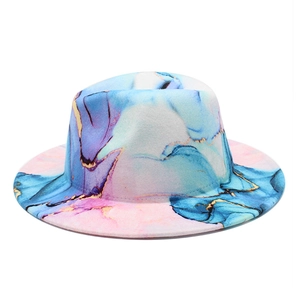 Detailed close-up of colorful marble print on a wide-brim felt fedora hat with gold accents