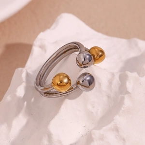 Macro view of double-layer stainless steel ring with gold and silver bead accents