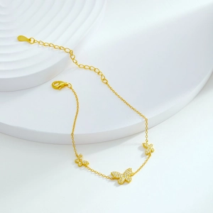 Close-up of gold S925 silver butterfly bracelet with sparkling zircon stones and lobster clasp