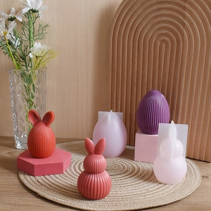 Detail of striped Easter egg and faceless bunny silicone molds for DIY candle making