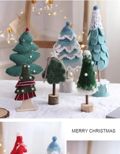 Close-up of wool felt Christmas trees with knit textures and rustic wooden bases