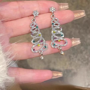 Festive silver Christmas tree drop earrings adorned with colorful sparkling gemstones