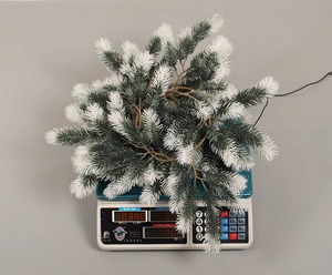 Close-up of artificial frosted pine branch for Christmas decor weighing 0.380kg