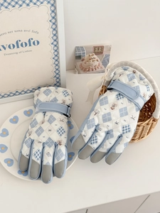 Detail of quilted ski gloves featuring teddy bear patterns and anti-slip palm texture