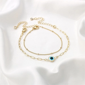 Bohemian gold stainless steel layered bracelet set featuring a blue evil eye pendant