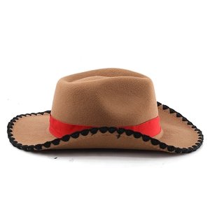 Detail of camel western cowboy felt hat with red ribbon and black stitched brim edge