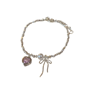 Sweet silver bow necklace with pink heart zircon and faux pearls on white background