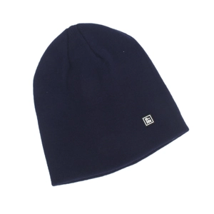 Detail of dark blue knit beanie showing the fine texture and square logo patch