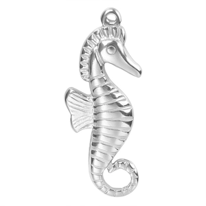 Macro shot of silver seahorse pendant with textured details and top loop for DIY jewelry