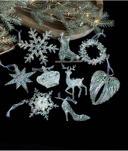 Detailed view of 9-piece iridescent acrylic Christmas tree hanging ornaments set on pine decor