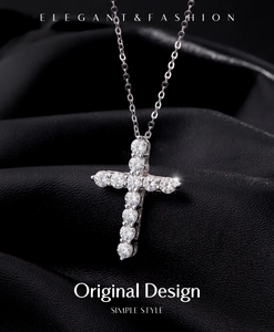 Macro detail of silver cross necklace featuring sparkling zircons on black leather
