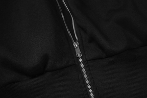 Detail of silver metal zipper on premium black knitted hooded jacket with smooth texture