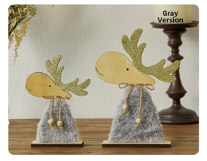 Detail of grey plush reindeer decor with wooden base and glitter antlers on table