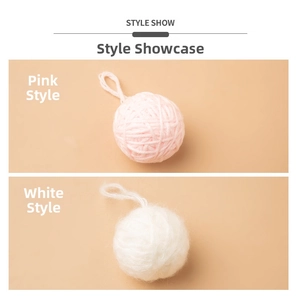 Detailed view of pink and white yarn ball hanging ornaments for Christmas DIY crafts