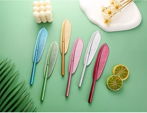Set of 6 realistic metal feather pens in vibrant colors over a mint green backdrop