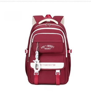 Front view of large capacity dark red nylon student backpack with white star charm