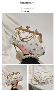 Detail of white lace shell bag with purple floral embroidery and pearl handle