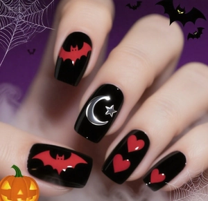 Detail of Halloween press-on nails featuring red bats and silver moon star patterns