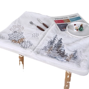 White plush Christmas table runner featuring embroidered snowflake and pine tree patterns