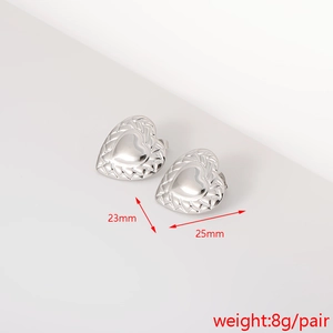 Detail of silver heart earrings with woven texture measuring 23mm by 25mm