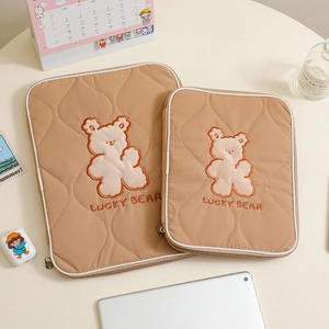 Quilted khaki laptop sleeve with cute Lucky Bear embroidery and a secure zipper closure