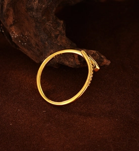 Macro shot of S925 sterling silver snake ring with sparkling zircon inlays on dark wood